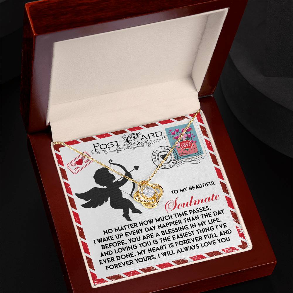 The Soulmate-Forever Yours Love Knot Necklace features a heart and cubic zirconia pendant in a wooden box. The lid's postcard design with Cupid and heartfelt text makes it a perfect gift for your soulmate.