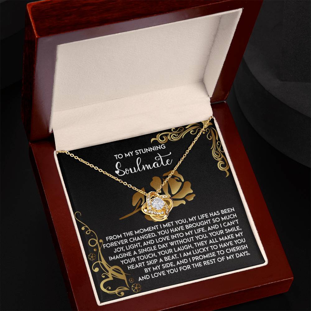 The Soulmate-I Met You 2 - Love Knot Necklace showcases a heart-shaped pendant with a gold finish, engraved romantic message for your soulmate, and sparkling cubic zirconia. It comes elegantly packaged in a jewelry box.