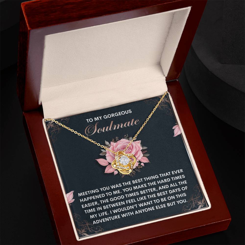 The Soulmate-Best Days - Love Knot Necklace, with a pendant of intertwined hearts adorned with sparkling cubic zirconia crystals, is displayed in an open box. The message inside reads: "To my gorgeous soulmate," followed by a loving note, creating the perfect personalized gift.