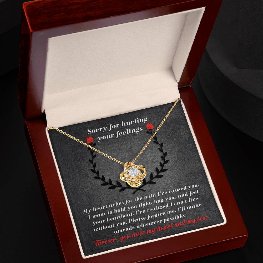 The Sorry-Make Amends - Love Knot Necklace, adorned with dazzling cubic zirconia crystals, rests elegantly in a jewelry box. Inside, there's a heartfelt apology note expressing profound regret and love, turning this personalized gift into something truly special.