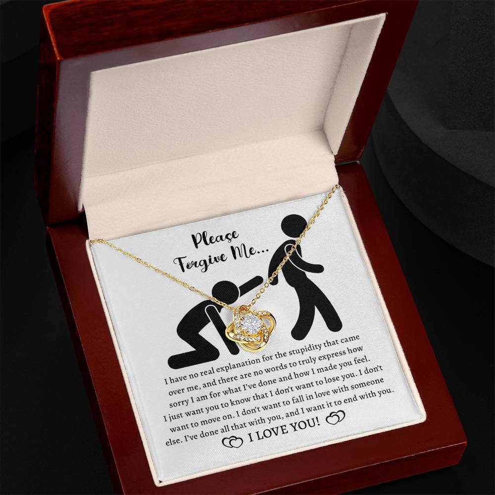 The Sorry-Made You Feel - Love Knot Necklace features intertwined hearts and is beautifully presented in a cushioned, open jewelry box. Elegantly adorned with premium cubic zirconia crystals and crafted from 14k white gold, the box displays the message "Please, forgive me" along with an apology note and "I LOVE YOU!" written at the bottom.