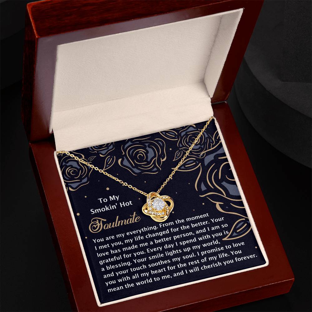 The Soulmate-My Soul 2 - Love Knot Necklace, featuring cubic zirconia crystals, arrives in a brown gift box with a heartfelt "To My Soulmate" note on the inside lid against a dark backdrop—making it an elegant and personalized gift.