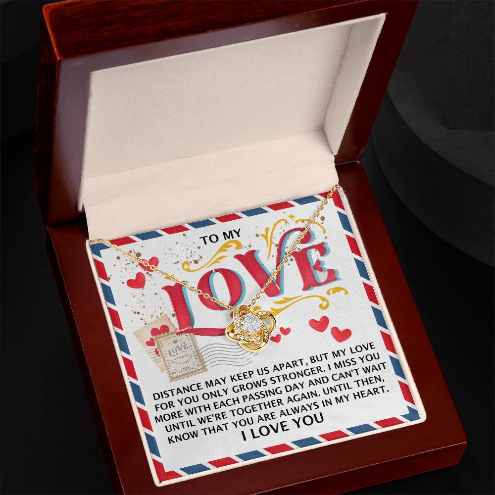 The Soulmate-In My Heart - Love Knot Necklace, beautifully accented with cubic zirconia crystals and crafted from 14k white gold, is elegantly packaged in a gift box featuring a heartfelt love message.