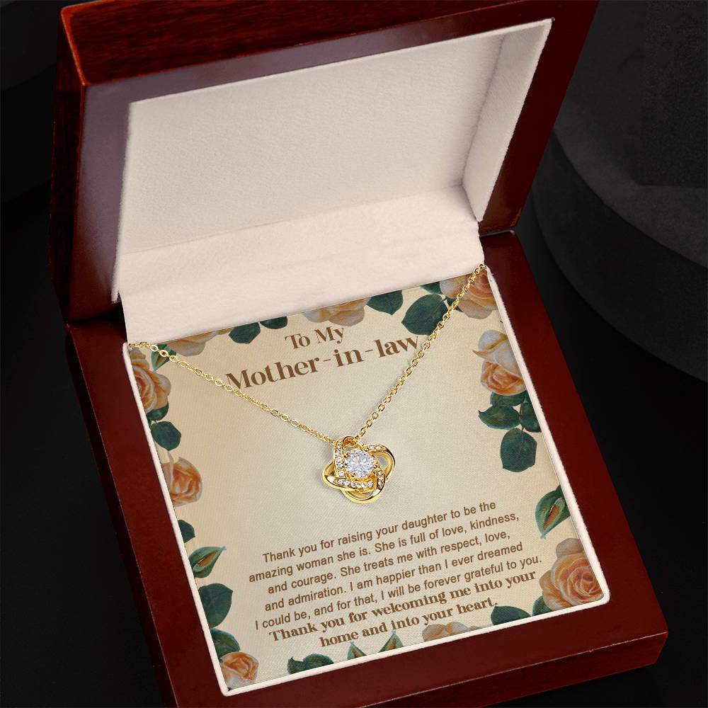 The "To Mother-in-law, Grateful To You - Love Knot Necklace" is a personalized gift that includes a gold necklace featuring a heart-shaped pendant, elegantly presented in a maroon box. The background card is adorned with rose patterns and expresses heartfelt gratitude to a mother-in-law. This Love Knot Necklace is beautifully crafted with cubic zirconia crystals for an additional touch of sparkle.