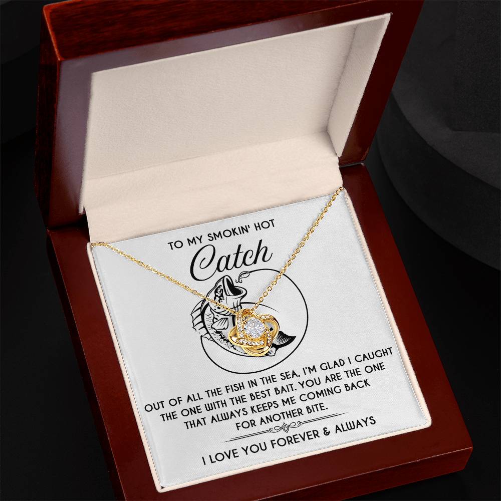 Open the jewelry box to reveal the Soulmate-Another Bite - Love Knot Necklace, its delicate gold finish catching the light. Inside, see a message with the words, "To my smokin’ hot catch.