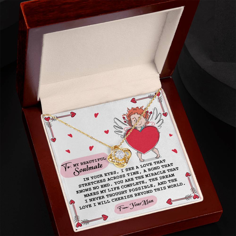 The Soulmate-No End - Love Knot Necklace, featuring a gold heart with a sparkling cubic zirconia, is presented in a box illustrated with cupid and an affectionate note from "Your Man" to "My Beautiful Soulmate.