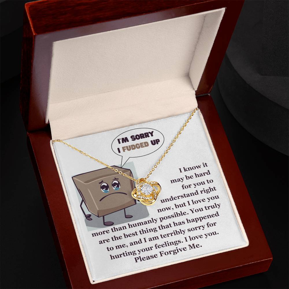 The "Sorry-The Best Thing" Love Knot Necklace, crafted in 14k white gold and adorned with shimmering cubic zirconia crystals, is presented elegantly in a box. The cover showcases an apologetic cartoon, expressing deep regret and asking for forgiveness.