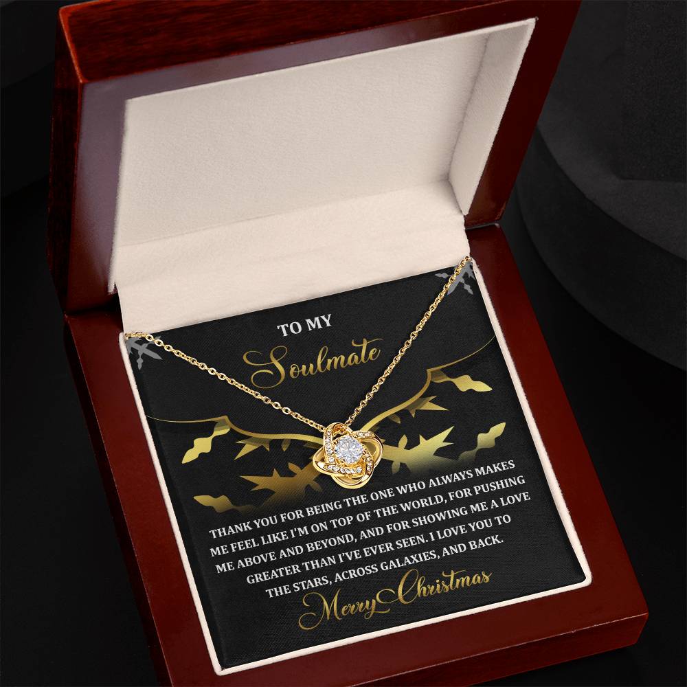 The Soulmate-A Love - Love Knot Necklace, designed in a heart shape and adorned with a cubic zirconia accent, is elegantly presented in a red jewelry box alongside an affectionate Christmas message on a black card.