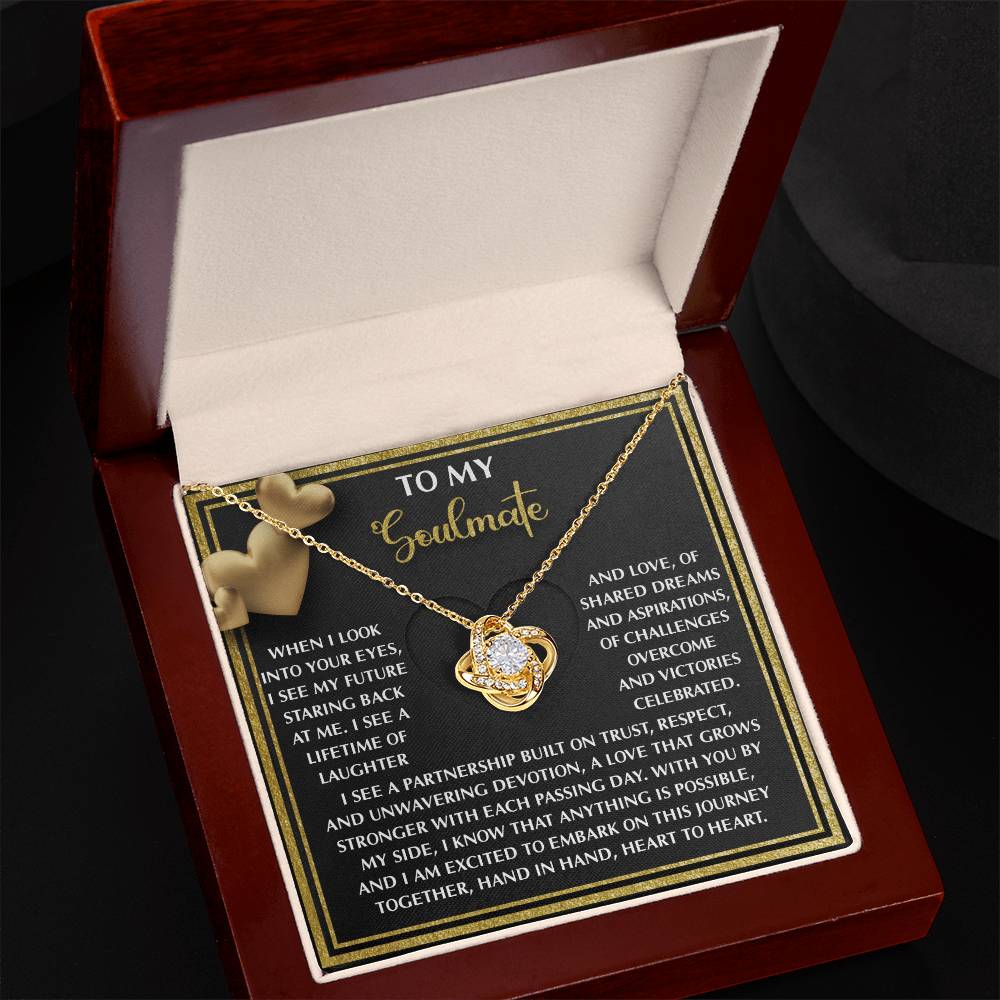 The jewelry box reveals a Soulmate-Heart To Heart Love Knot Necklace adorned with cubic zirconia crystals and an intertwined heart design. It rests on a black card with the message "To My Soulmate," making it a unique gift that beautifully captures the essence of love.
