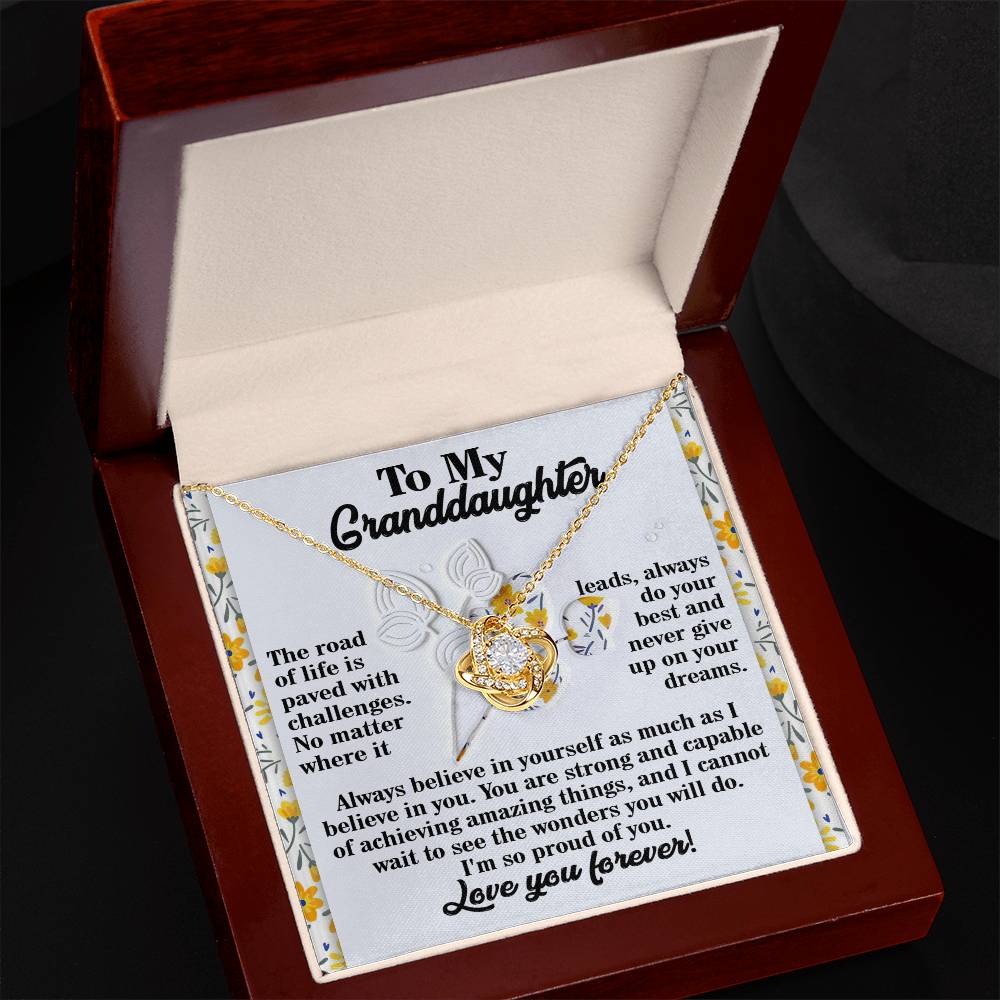 The Granddaughter-On Your Dreams - Love Knot Necklace is elegantly displayed in an open box, crafted from 14k white gold and adorned with sparkling cubic zirconia crystals. It comes with a heartfelt message card that symbolizes belief, strength, and love for a granddaughter.
