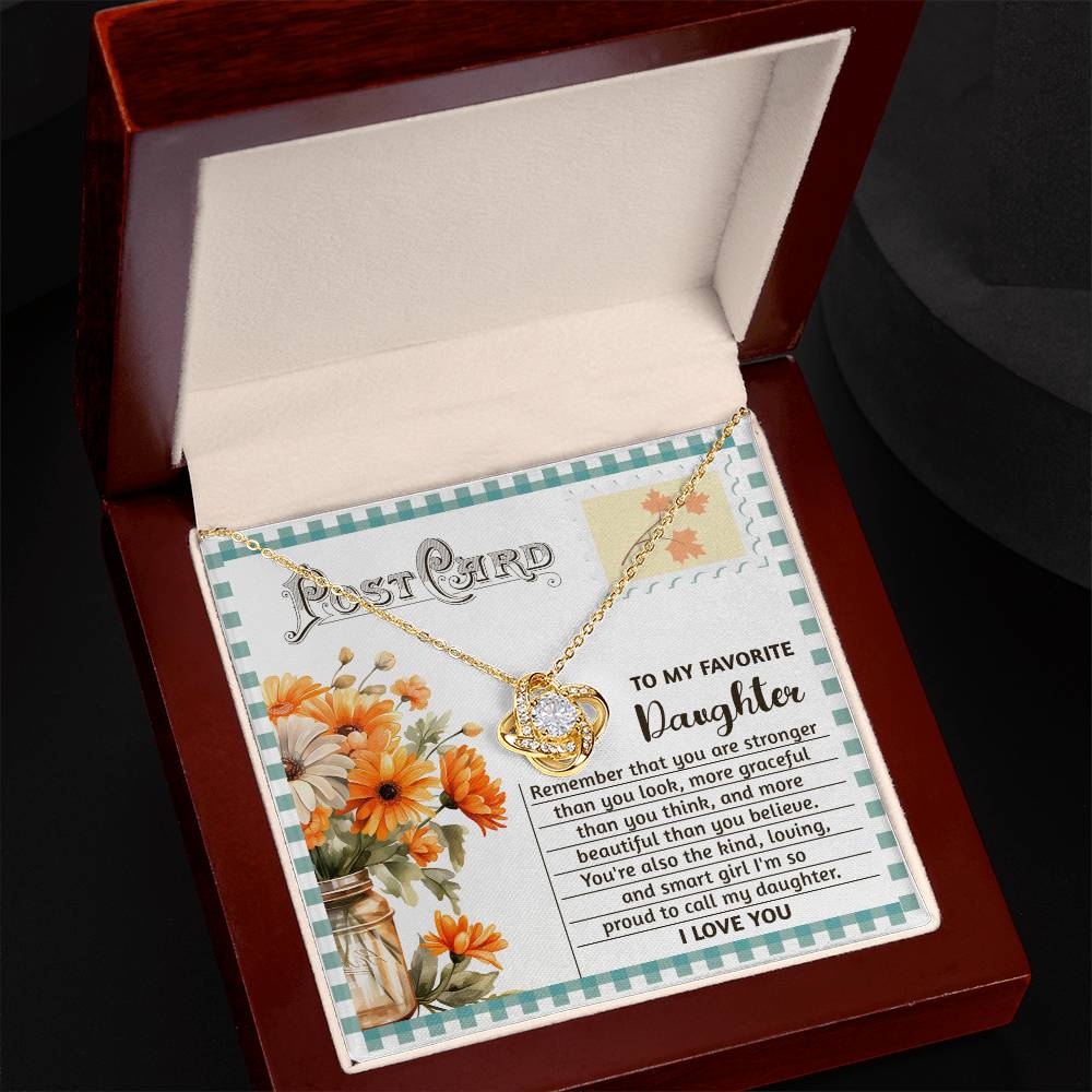 The Daughter-Smart Girl - Love Knot Necklace, embellished with cubic zirconia crystals and elegantly presented in a red jewelry box along with a floral card bearing a heartfelt message for a daughter, creates an unforgettable personalized keepsake.