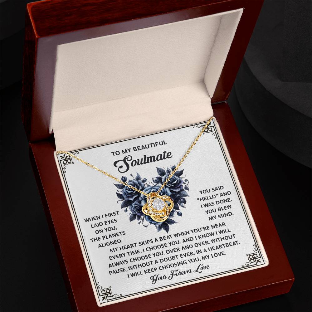 The Soulmate-Skips A Beat - Love Knot Necklace, adorned with cubic zirconia crystals, comes in a red velvet box. It includes a card with floral designs and a romantic message for your soulmate, making it the perfect personalized gift.