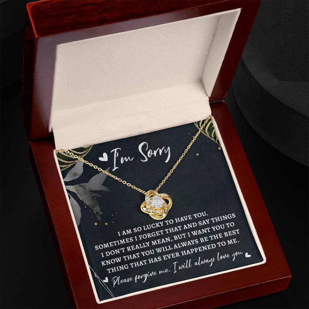 The "Sorry-The Best Thing - Love Knot Necklace" is presented in a small, open box that includes an apology message saying "I'm Sorry," along with a heartfelt note expressing regret and love. The necklace showcases a premium cubic zirconia centerpiece, making it the ideal personalized gift to mend hearts.