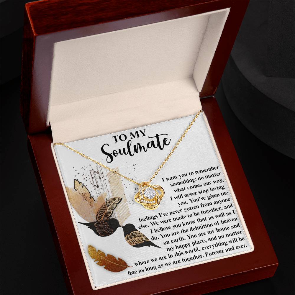 The Soulmate-Given Me Feelings - Love Knot Necklace, adorned with shimmering cubic zirconia crystals, is elegantly displayed in an open jewelry box. The box features an inscription titled "To My Soulmate," conveying love and eternal commitment.