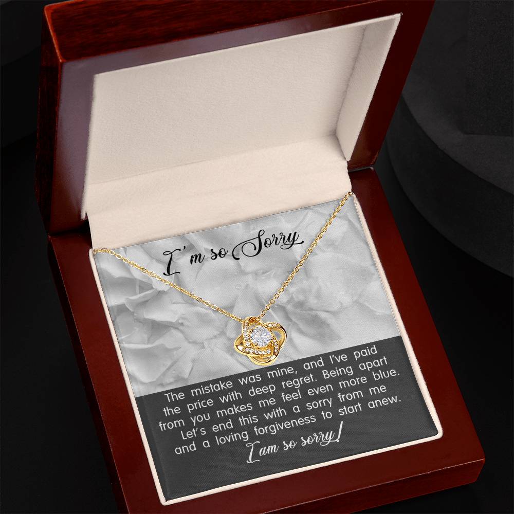 A personalized gift, the Sorry-With Deep Regret - Love Knot Necklace with an intertwined heart pendant features sparkling cubic zirconia crystals, presented in an elegant box accompanied by a heartfelt apology note.