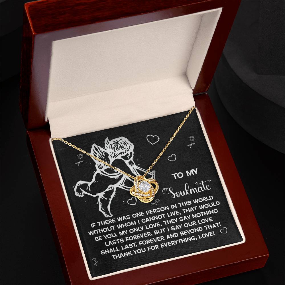 The Soulmate-Lasts Forever Love Knot Necklace features a heart pendant and shimmering cubic zirconia crystals, presented in a velvet-lined wooden box. The lid reads "To my soulmate," with a cherub illustration and heartfelt message, making it the perfect personalized gift.