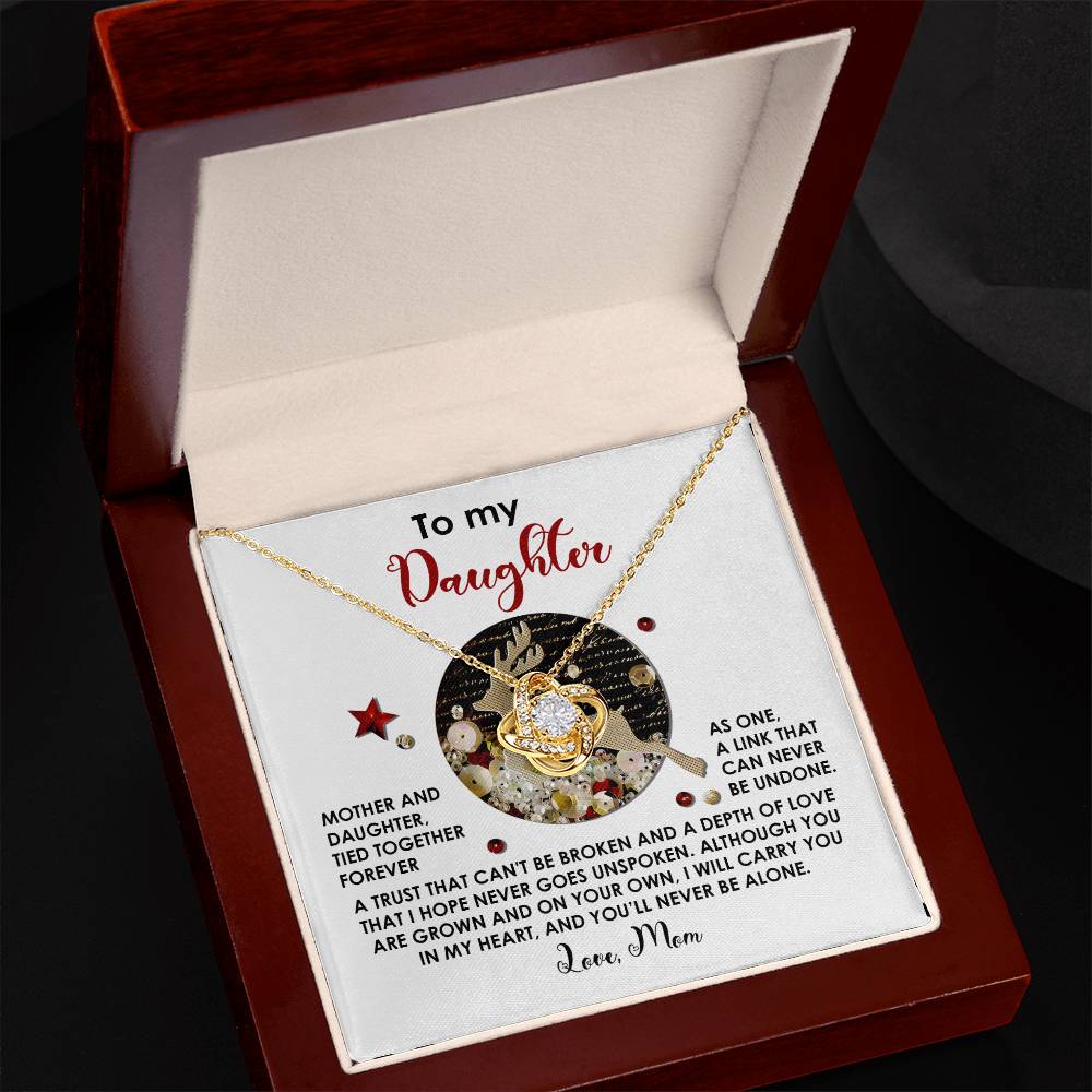 The Daughter-Forever As One - Love Knot Necklace, adorned with dazzling cubic zirconia crystals, is elegantly arranged in a jewelry box that includes a heartfelt message for a daughter on the inside lid—making it an exceptionally unique gift.