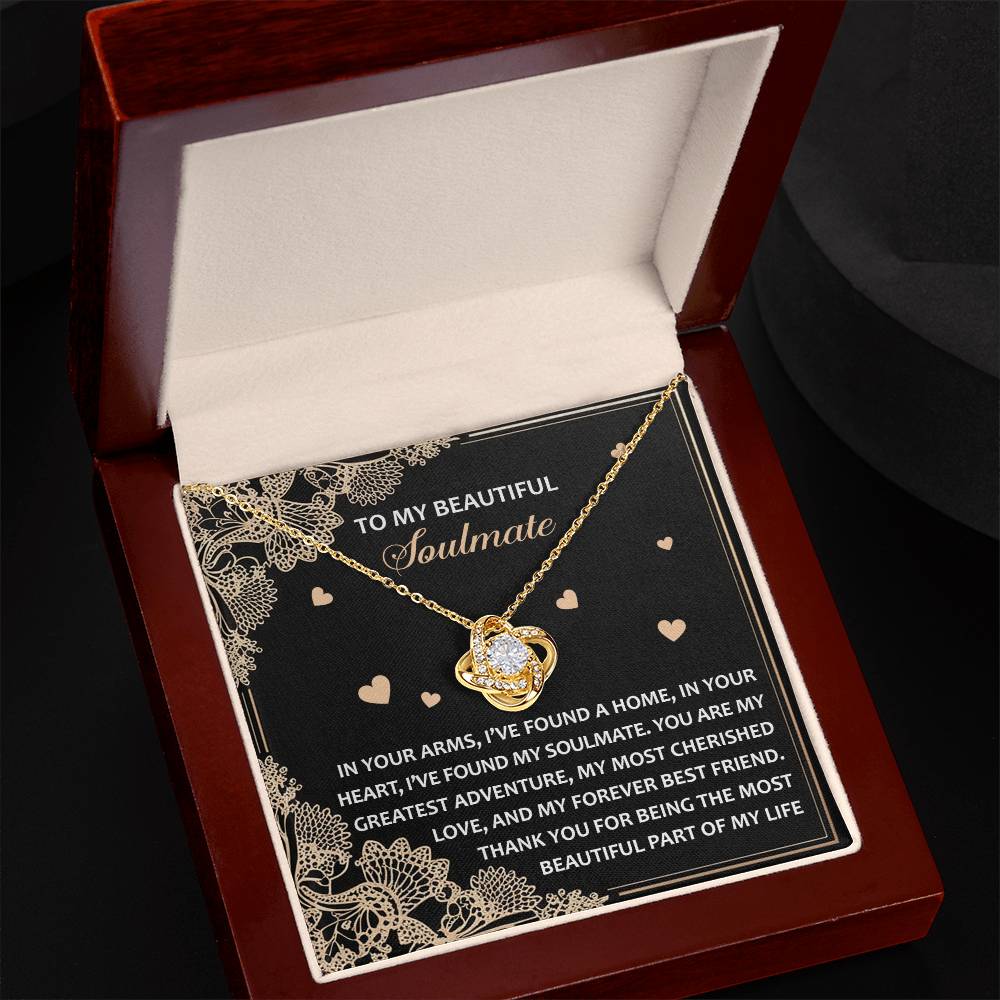 The Soulmate-Beautiful Part - Love Knot Necklace rests elegantly in a wooden box, adorned with cubic zirconia crystals. A romantic message on a black card background enhances this classic gift, perfect for special moments.