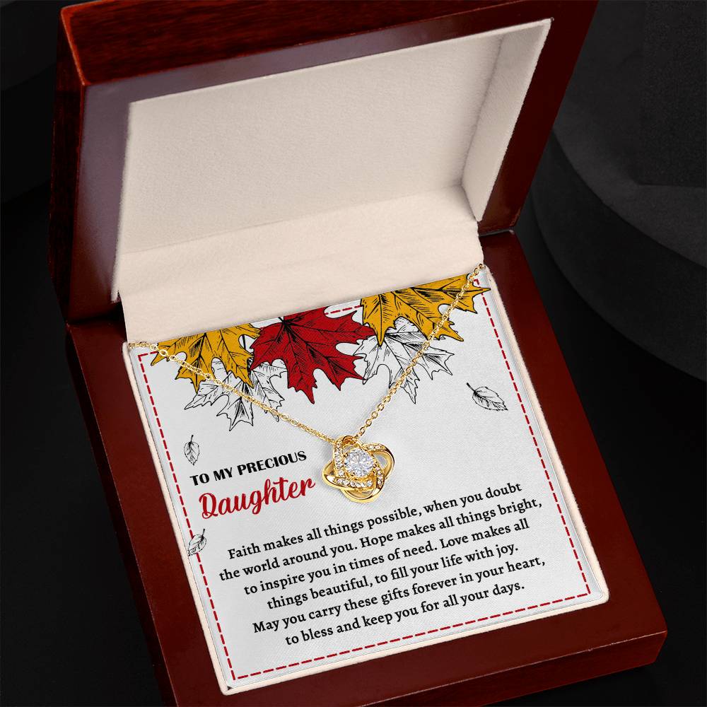 A Daughter-Fill Your Life - Love Knot Necklace in a gift box with a heartfelt message for your daughter. The note highlights faith, hope, and love, complemented by cubic zirconia crystals and an illustration of autumn leaves.