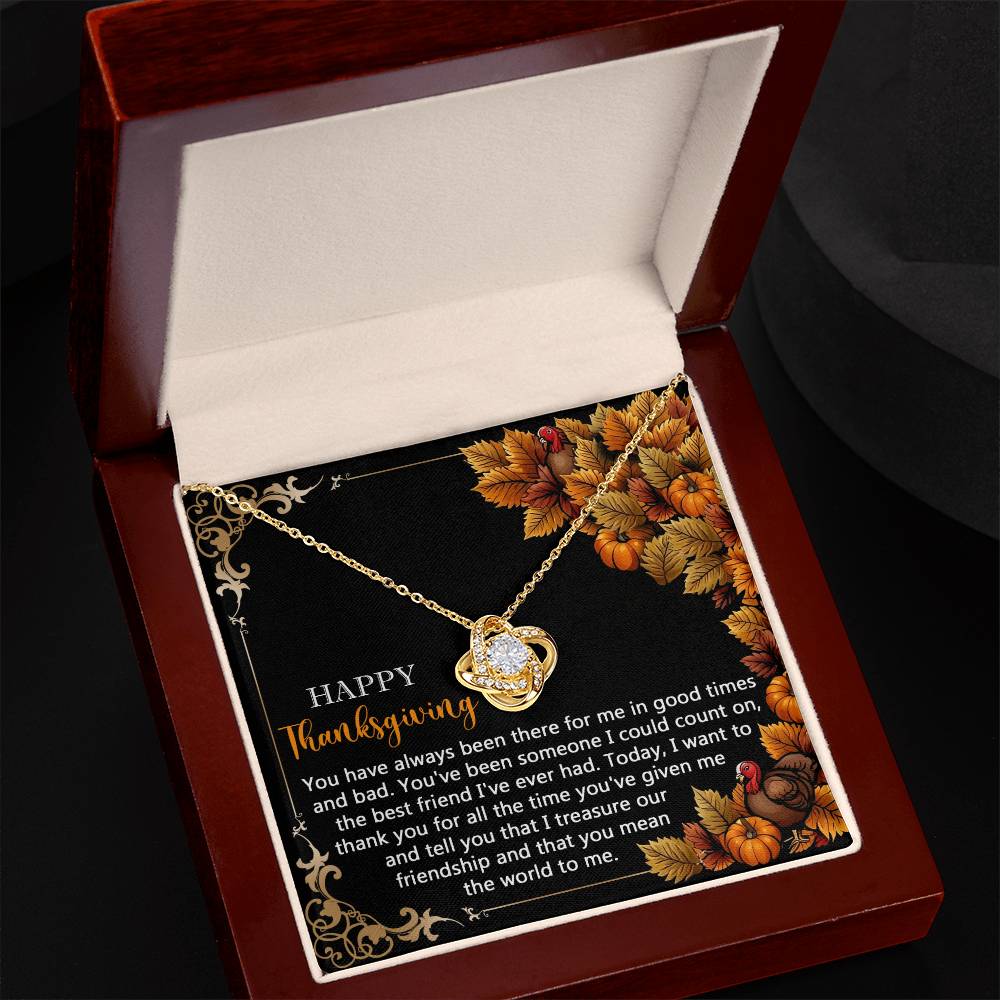 The Thanksgiving-Count On - Love Knot Necklace features an intertwined heart pendant beautifully displayed in a jewelry box. The inside lid showcases a warm Thanksgiving message set against autumn leaves decor. With its gold finish and sparkling cubic zirconia accents, the pendant elegantly symbolizes everlasting love and gratitude.