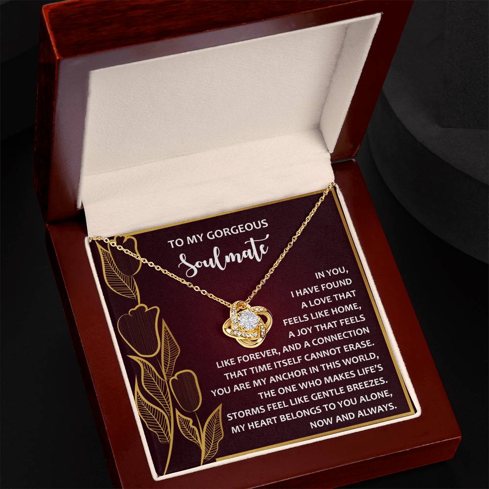 The Soulmate-Gentle Breezes - Love Knot Necklace is a gold heart-shaped treasure adorned with cubic zirconia. Housed in a box with an inscription about soulmates, it features exquisite floral designs—a perfect personalized gift for someone special.