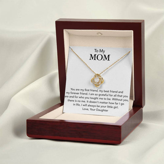 A boxed "To My Mom, You Are My First Friend - Love Knot Necklace" adorned with premium cubic zirconia crystals, accompanied by a note that reads: "To My MOM - You are my first friend, my best friend and my forever friend... Love, Your Daughter. Our unbreakable bond shines as brightly as this necklace.