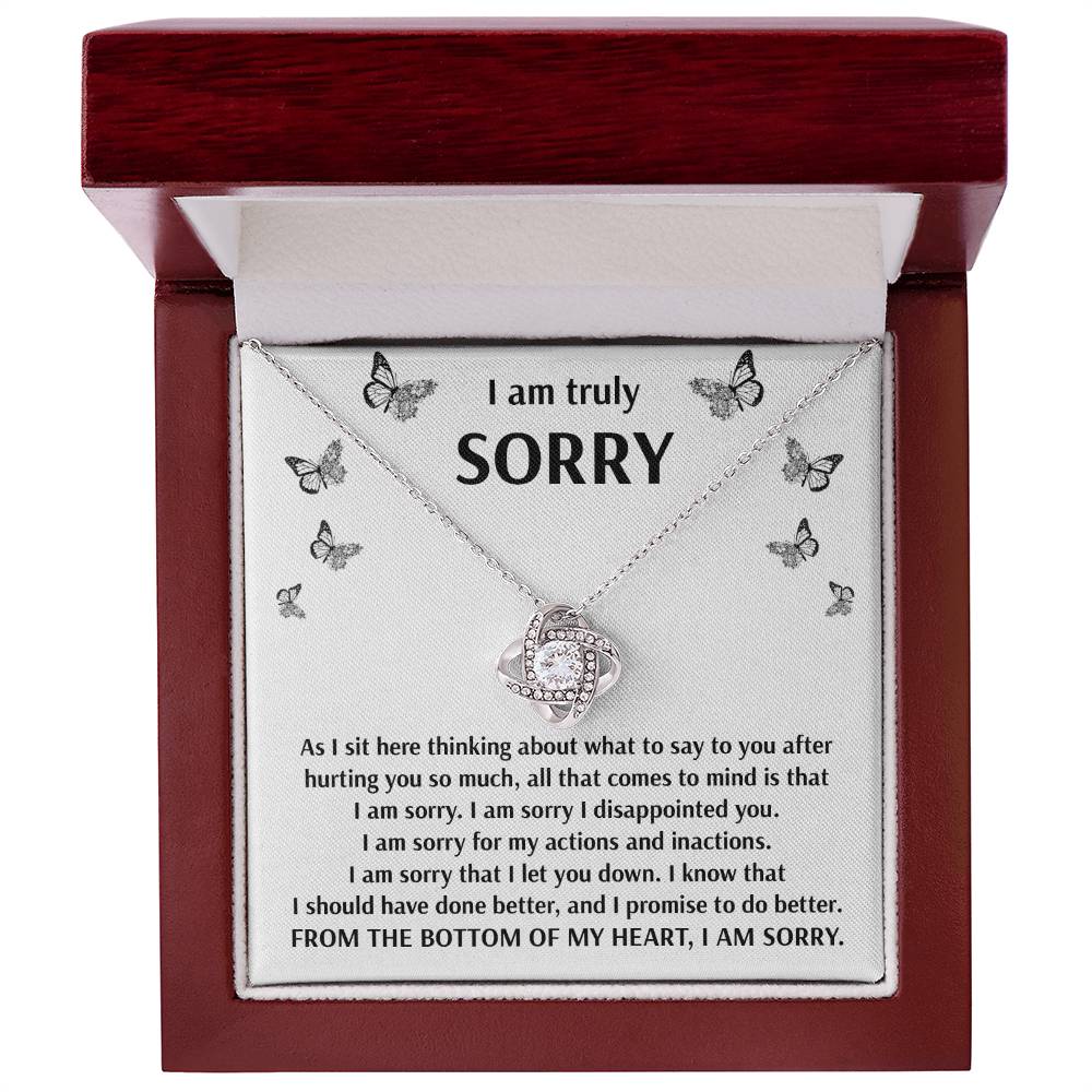 Introducing the "Sorry-Done Better" Love Knot Necklace, elegantly presented in a red box with a heartfelt apology message inside. Crafted with shimmering cubic zirconia crystals and 14k white gold, this necklace symbolizes your promise to do better and conveys sincere remorse.