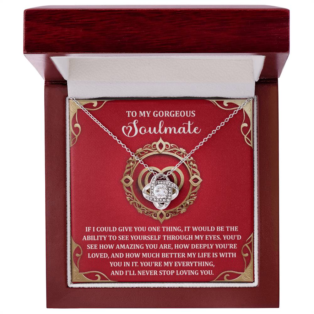 The Soulmate-Through My Eyes Love Knot Necklace, in a red box, includes a heart-shaped pendant adorned with cubic zirconia and comes with a heartfelt message for your soulmate. It's an ideal gift for your loved one to cherish forever.