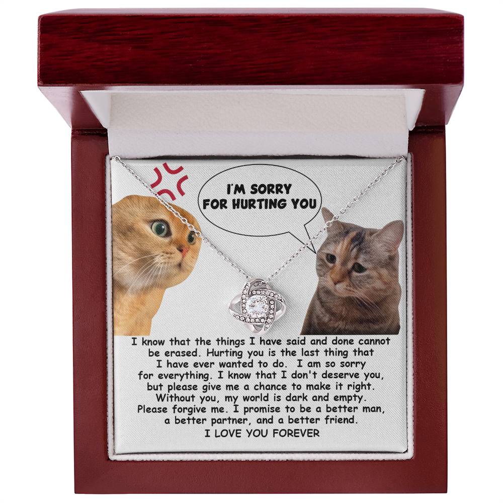 The Sorry-Make It Right - Love Knot Necklace showcases a heartfelt note adorned with two cats, one angry and the other sad. The note conveys remorse with the message, "I'm sorry for hurting you," alongside a promise to improve. Enhanced by cubic zirconia crystals and personalized for an intimate touch, it reads "I LOVE YOU FOREVER.