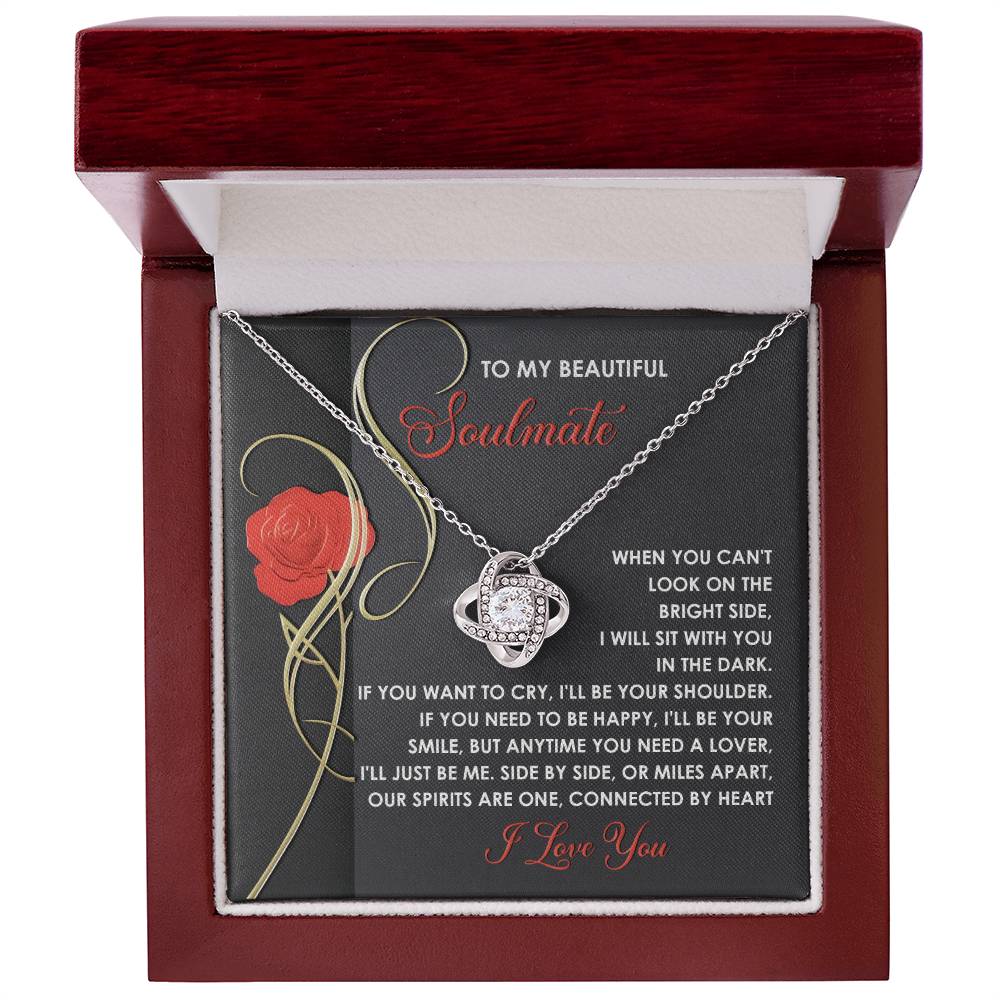 The Soulmate-Be Me - Love Knot Necklace features gold-finished interlocking rings with cubic zirconia, nestled in a box. The included card expresses heartfelt love and unwavering support for a soulmate.