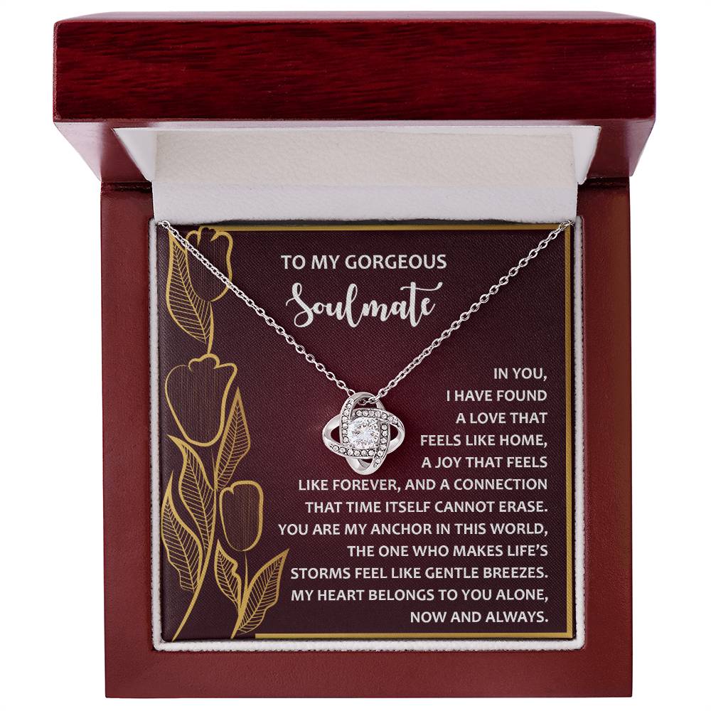 This elegant Soulmate-Gentle Breezes - Love Knot Necklace features cubic zirconia crystals and comes in a red box with an inscription about love and connection. Its enchanting floral design adds charm to this personalized gift.