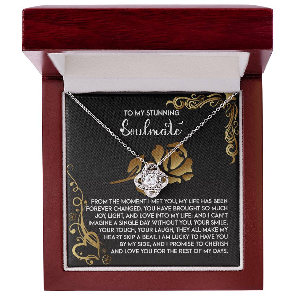 The "Soulmate-I Met You 2 - Love Knot Necklace" features interlocking hearts adorned with cubic zirconia, nestled in a wooden box with a heartfelt message to a soulmate. This personalized gift captures the essence of eternal love and connection.