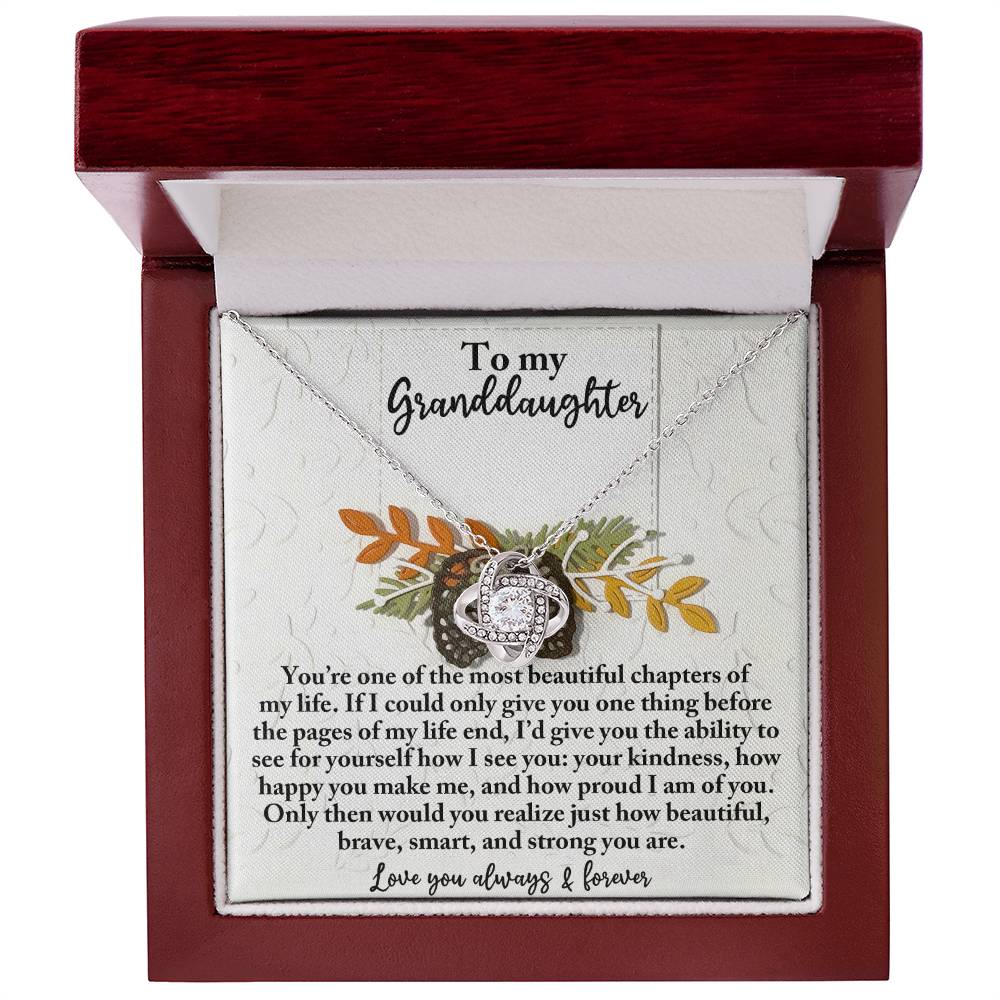 The Granddaughter-How Beautiful Love Knot Necklace, adorned with cubic zirconia crystals in its box, serves as a personalized gift that conveys love and appreciation to a granddaughter.
