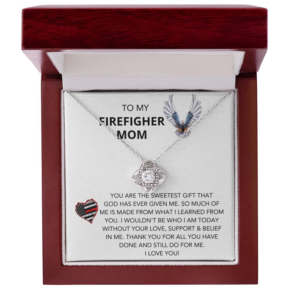 A personalized To Dog Mom, Pawtrick Day - A Better Life Love Knot Necklace in a wooden box by ShineOn Fulfillment.