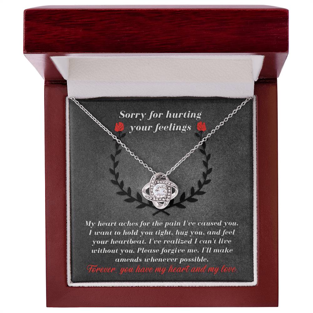 A Sorry-Make Amends - Love Knot Necklace in an open red box with a heartfelt apology message on the inner lid, adorned with sparkling cubic zirconia crystals, expressing remorse and a promise to make amends.