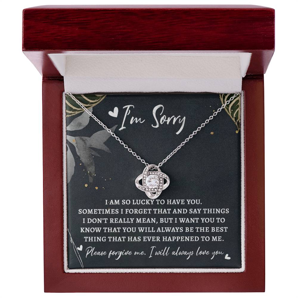 The Sorry-The Best Thing - Love Knot Necklace, featuring a planet-shaped pendant and adorned with premium cubic zirconia, is beautifully displayed in a red box. Accompanied by a card that reads "I'm Sorry" and includes an apology message expressing love and regret, this personalized gift elegantly conveys heartfelt emotions.