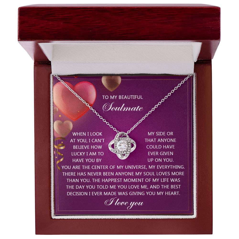 Inside the jewelry box is the stunning Soulmate-My Soul - Love Knot Necklace, elegantly enhanced with cubic zirconia crystals. In the background, a purple card displays a heartfelt romantic message to a soulmate.