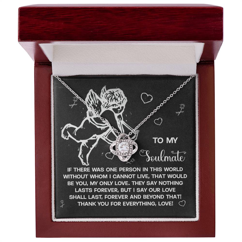 The Soulmate-Lasts Forever Love Knot Necklace, adorned with cubic zirconia crystals, comes in a gift box featuring Cupid's illustration and a romantic message labeled "To My Soulmate," beautifully capturing your love's essence.