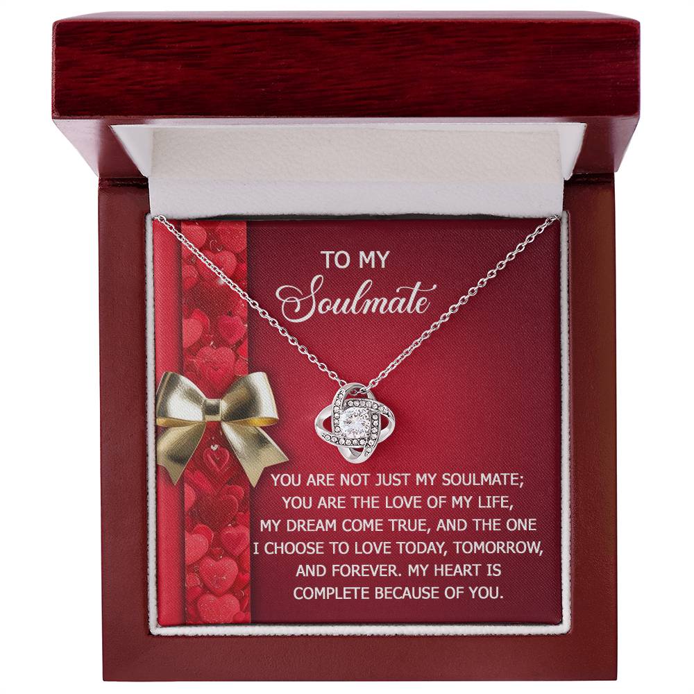 The Soulmate-Because Of You - Love Knot Necklace is crafted in 14k white gold and adorned with cubic zirconia crystals. It comes in a gift box with a "To My Soulmate" message card, featuring a heart design and romantic message.