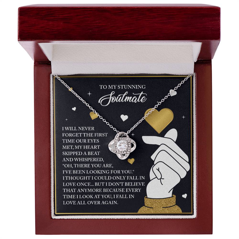 The Soulmate-Look At You - Love Knot Necklace, featuring sparkling cubic zirconia crystals, is beautifully presented in a red box. With an accompanying heartfelt card about meeting your soulmate, this gold finish piece embodies the essence of true love.