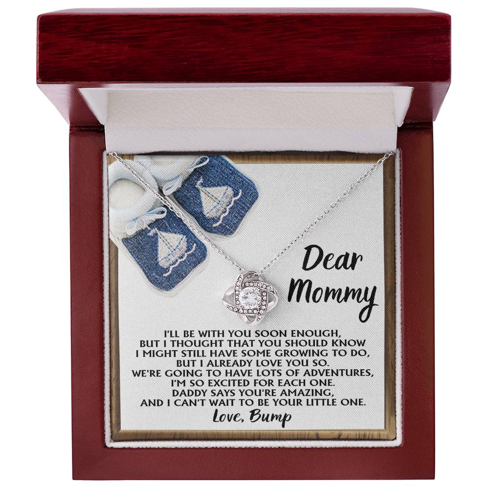 The "To Mom To Be, You're Amazing - Love Knot Necklace" comes beautifully presented in a red jewelry box with cubic zirconia crystals, accompanied by a heartfelt note addressed to "Mommy" from "Bump," expressing excitement for future adventures and love.