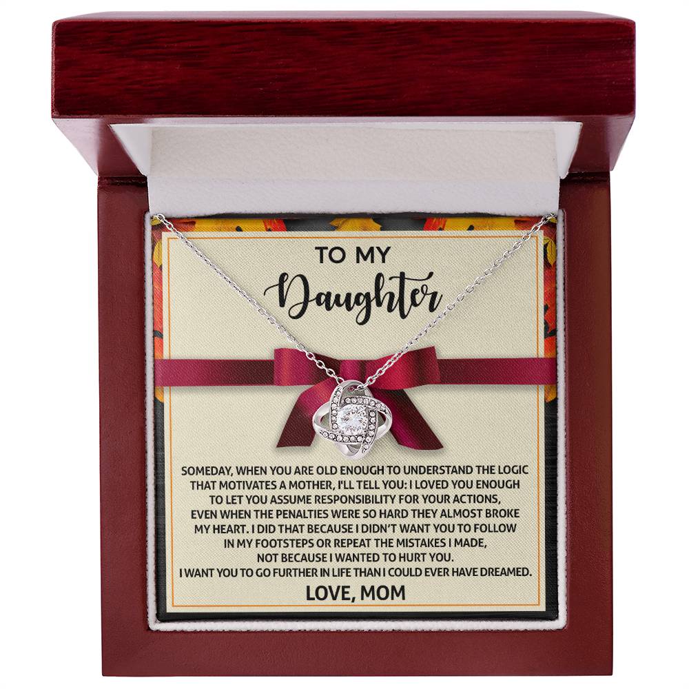 Introducing the Daughter-Further In Life - Love Knot Necklace, elegantly presented in a box that features a heartfelt message from a mother to her daughter displayed on the inside of the lid. This beautiful necklace is available in either white gold or yellow gold finish and is adorned with shimmering cubic zirconia crystals.
