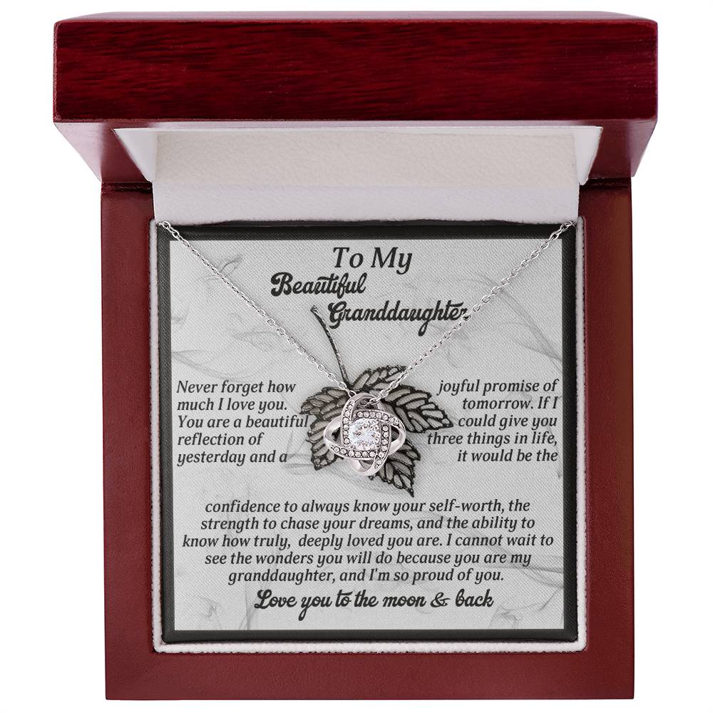 This personalized gift, the "Granddaughter-Deeply Loved - Love Knot Necklace," features a heart-shaped pendant adorned with sparkling cubic zirconia crystals and is beautifully presented in a box with a heartfelt message for your granddaughter.