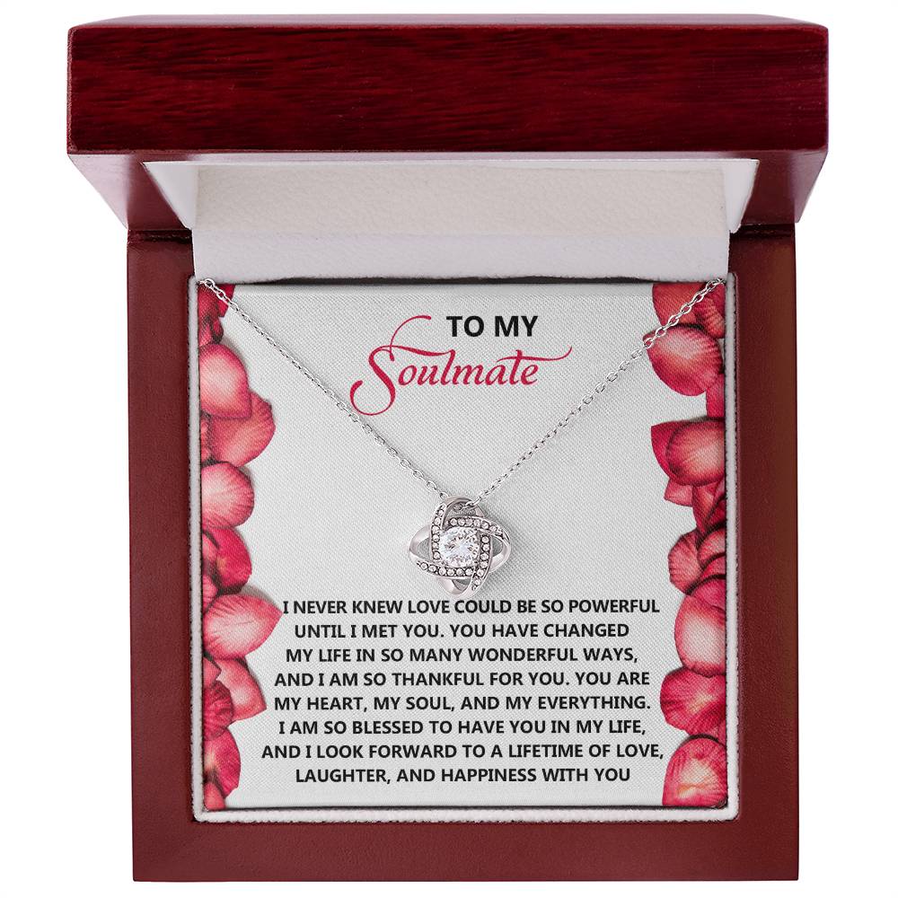 The Soulmate-Until I - Love Knot Necklace, nestled in a red box adorned with cubic zirconia crystals and rose petals, features a heartfelt message to symbolize an unbreakable bond with your soulmate.
