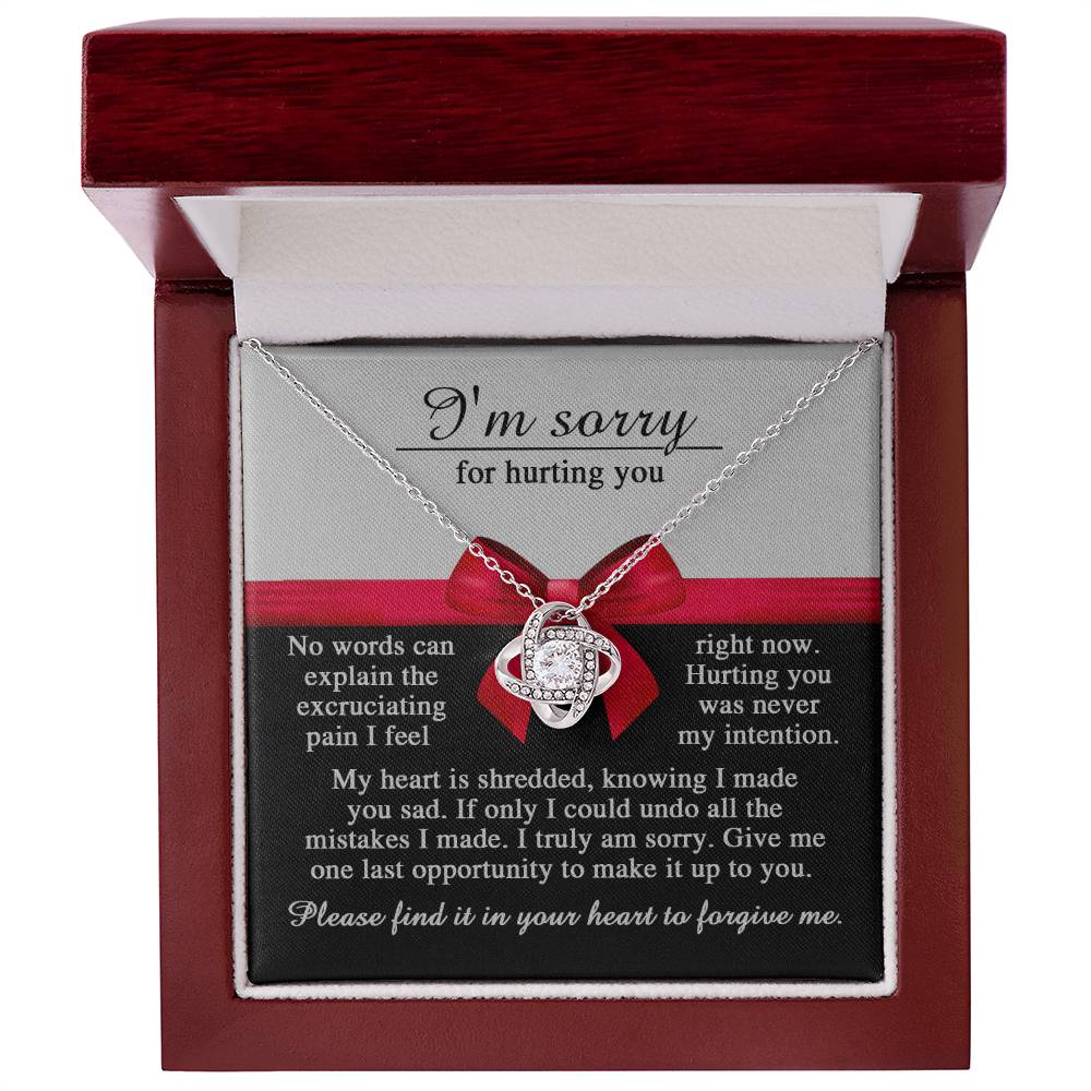 The Sorry-Made You Sad - Love Knot Necklace comes beautifully packaged in a gift box with an apology message, conveying heartfelt regret for causing hurt and seeking forgiveness. This necklace boasts an intertwined design featuring a central gemstone and sparkling cubic zirconia crystals, making it a deeply personalized gift.