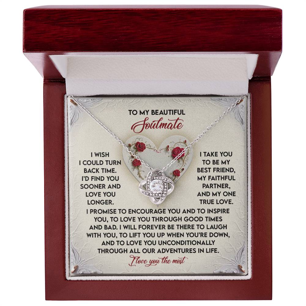 Open the jewelry box to reveal the Soulmate-Laugh With You - Love Knot Necklace, adorned with cubic zirconia crystals. The heart-shaped pendant is available in white or yellow gold finish, nestled among roses with a heartfelt "Soulmate" message on the card beside it.