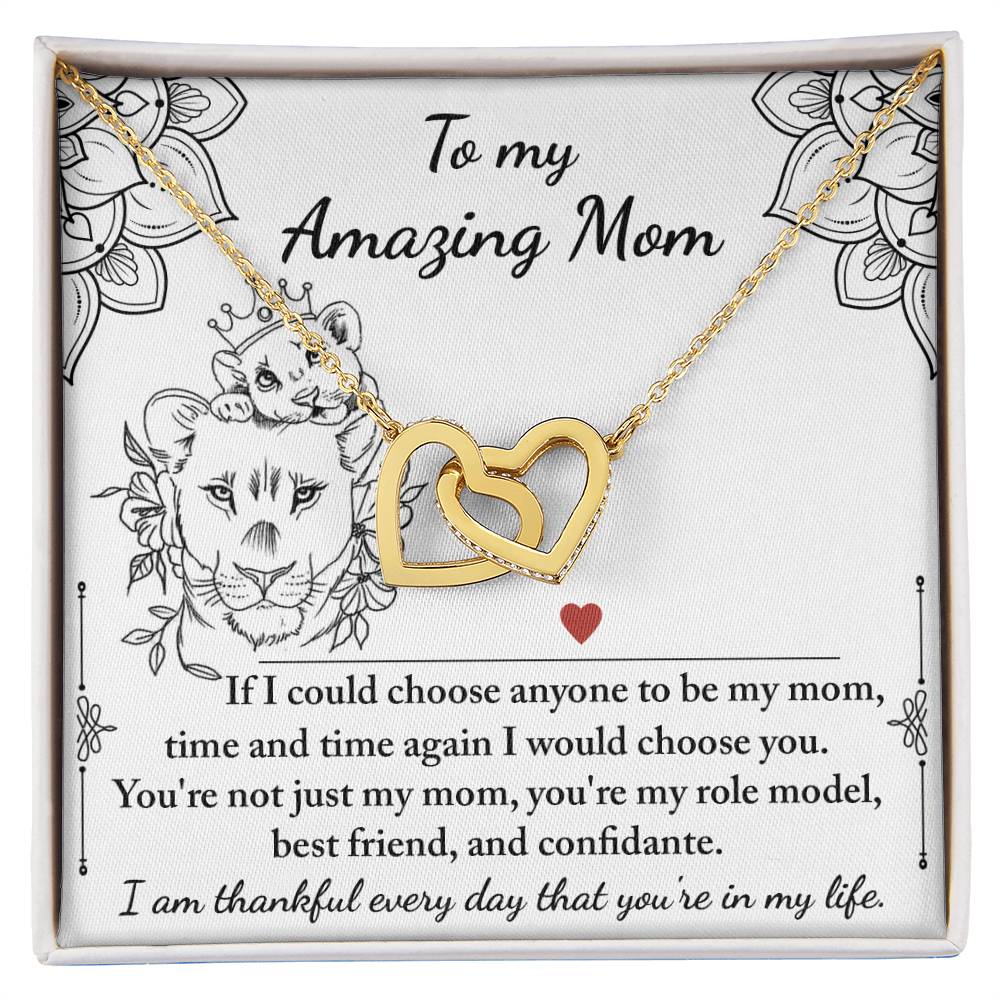 The "To Mom, Be My Mom - Interlocking Hearts Necklace" is presented on a card with a heartfelt message and adorned with shimmering cubic zirconia crystals, featuring floral and heart designs that symbolize endless love and appreciation.