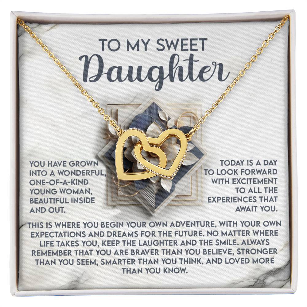 The Daughter-For The Future - Interlocking Hearts Necklace, adorned with cubic zirconia crystals, elegantly rests on a decorative card with the message "To My Sweet Daughter," featuring inspiring words about uniqueness, strength, and future adventures.