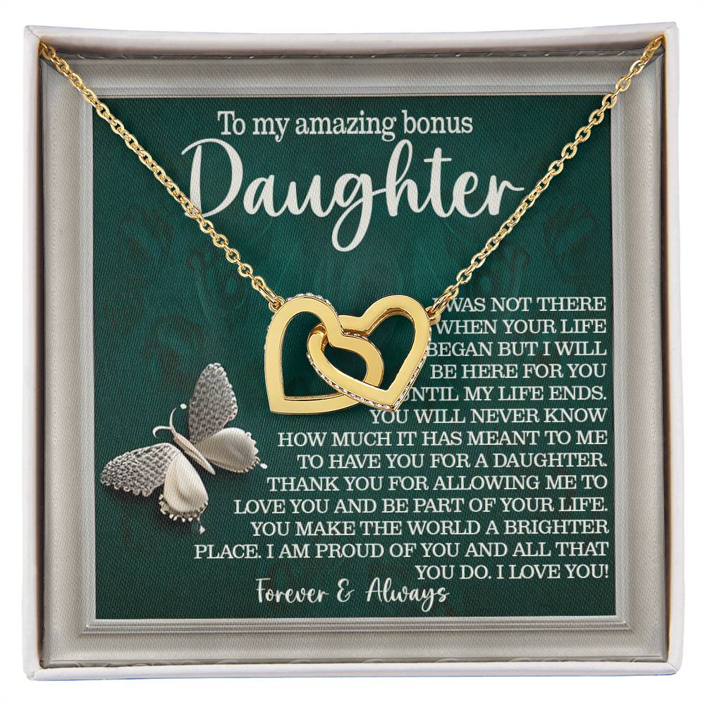 The "Daughter-Your Life - Interlocking Hearts Necklace" features a rose gold finish and a silver butterfly. It comes in a box with the message "To my amazing bonus Daughter," adorned with twinkling cubic zirconia crystals, making it a heartfelt gift of love and appreciation.