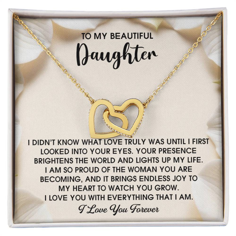 The Daughter-Into Your Eyes - Interlocking Hearts Necklace has a rose gold finish with shimmering cubic zirconia crystals, presented on a card with a heartfelt message of love and pride for your daughter.